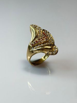 an image of a gold ring with red and white diamonds on it