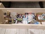 a drawer full of pens, pencils, and other office supplies