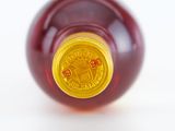 a close up of a bottle of wine on a white surface
