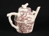 a brown and white teapot with a bird on it