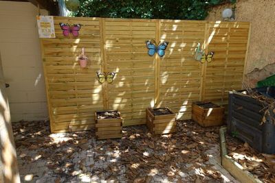a wooden fence that has a bunch of items on it