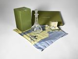 a green box and a glass vase sitting on a table
