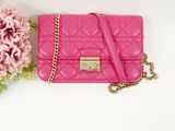 pink quilted purse with chain and flowers on a white background