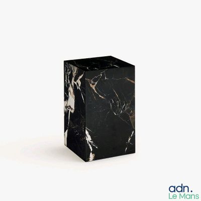 a black and white marble block on a white background