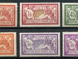 a group of six different colored postages on a black surface