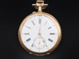 a gold pocket watch with roman numerals on it