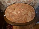 a small table with a marble top on a wooden floor