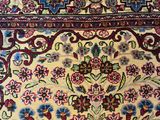 an oriental rug with a floral design on a wooden floor