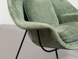 an image of a green chair sitting on top of a gray floor