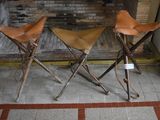 two leather stools sitting next to each other on the floor