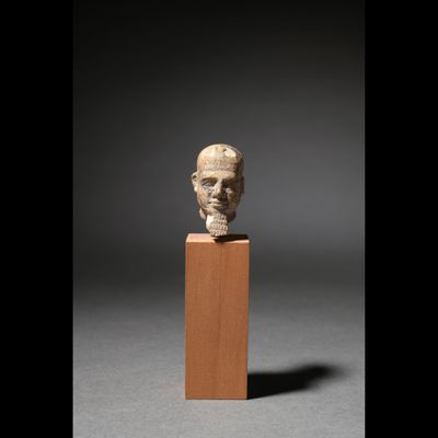 TETE DE PTAH Calcaire et trace d'alliage cuivreux.