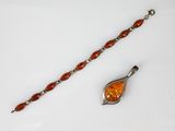 an image of a bracelet with an orange glass bead and a silver clasp