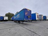 a blue trailer that is parked in a parking lot