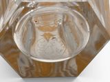 a glass ashtray with a brown and white design on it