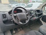 a dashboard and steering wheel of a car in a parking lot