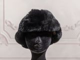 a black mannequin head with a fur hat on it