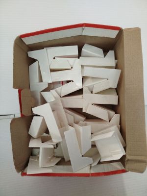 a cardboard box filled with white boxes on top of a table