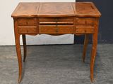 a wooden desk with drawers and a drawer underneath it