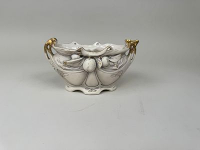 an image of a white bowl with gold handles on a white surface