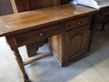 a wooden desk with a drawer on top of it