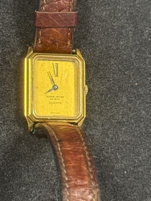 an image of a yellow watch sitting on top of a brown leather strap