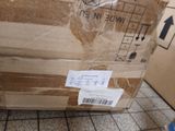 a cardboard box that is sitting on a tiled floor