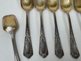 five spoons and a ladle on a white table