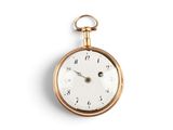 a gold pocket watch with roman numerals on the face