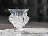 a glass vase sitting on top of a marble table