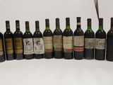 several bottles of wine are lined up in a row on a table