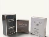 two boxes of perfume are sitting next to each other on a white surface