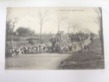 a black and white photo of a group of people riding horses