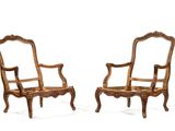 pair of carved wood armchairs with arms and legs