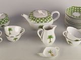 many cups and saucers that are sitting on a table