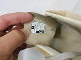 a hand that is holding a shoe with a label on it
