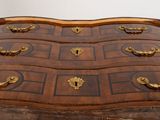 a wooden chest of drawers with many drawers on it