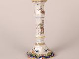 a white and blue vase sitting on a table