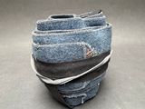 a stack of blue jeans stacked on top of each other
