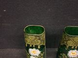 two vases that have daisies in them on a table