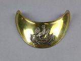 a gold plate with a bird and a boat on it