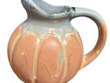 an image of a ceramic pitcher on a white background