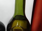 two bottles of wine sitting next to each other on a table