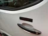 a close up of a car door handle with a sticker on it