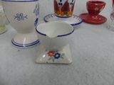 many different types of vases and cups on the table