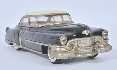 a black and gold toy car on a white surface