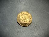 a close up of a gold coin sitting on top of a table
