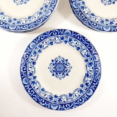 three blue and white plates with designs on them sitting on a table