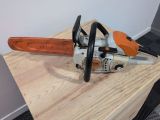 a close up of a chainsaw sitting on a wooden table