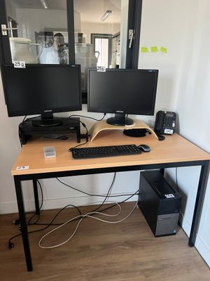un bureau équipé de deux écrans et d'un clavier