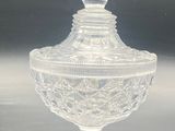 clear glass lidded jar with a decorative design on the top